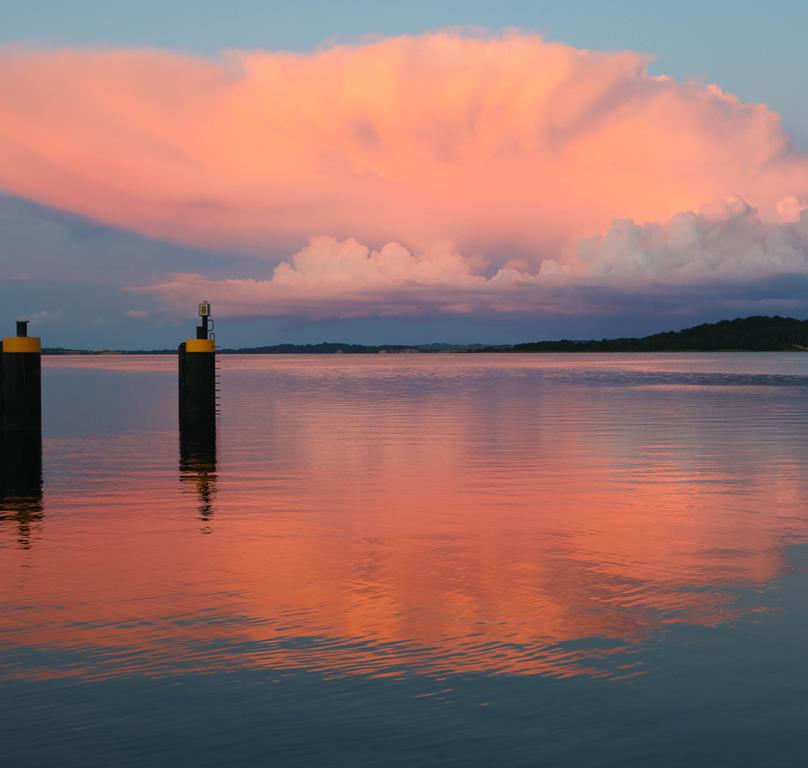 Der Sonnenuntergang taucht den Hafen von Lauterbach auf Rügen in warmes Licht